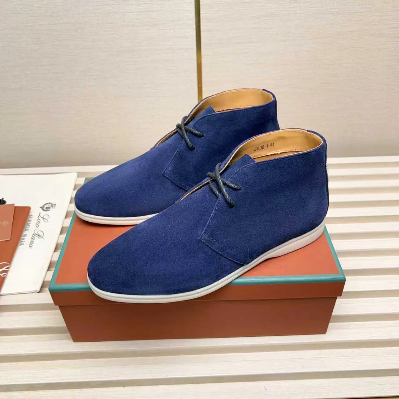 Men's Shoes 💰420 Loro Piana reimagines the desert boot—a modern, comfortable interpretation of a classic 1940s style. Crafted from suede calfskin, it exudes elegance. The tight texture of suede calfskin is not only durable but also looks casual and sophisticated. Add a timeless piece to your shoe collection, harmoniously blending comfort, style and Loro Piana's heritage of craftsmanship. Acetate satin detail on the inside White sole with LP lettering for added traction Space for a personalized signature on the heel Tonal suede trim Upper: 100% cow split suede Sole: 100% Rubber lining: Cow leather